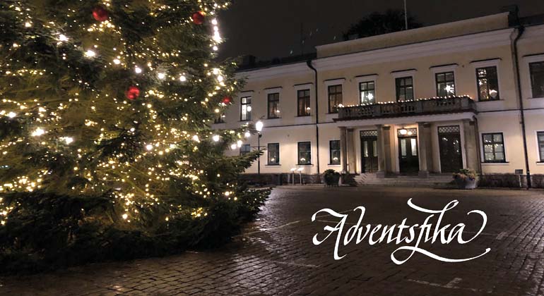 En mörk kväll på Stortorget i Växjö. Residenset i bakgrunden och en nederdelen av en stor  julgran till vänster. Foto.