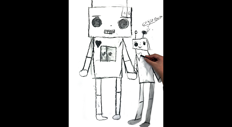 En hand som tecknar två robotar på ett ritpapper.