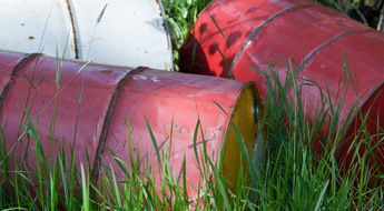 Hazardous barrels in the grass